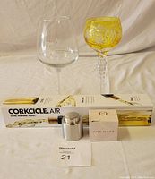 Two wine glasses (etched Gettysburg Tavern and yellow crystal cut) alongside boxed Corkcicle Air wine cooler and a One Hope wine stopper box, with auction lot number.