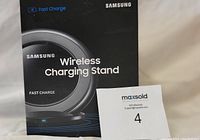 Box front view showing Samsung Wireless Charging Stand branding and fast charge feature.