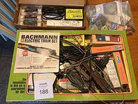 Box containing Bachmann N scale electric train set with multiple tracks, accessories, and packaging showing the set's branding and contents.