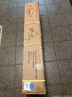 Photo of the cardboard box containing the rowing machine, showing dimensions and model information.