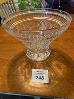 Full view of bowl on wooden table with auction tag visible