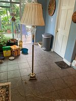 Full view of the floor lamp with pleated shade and power cord