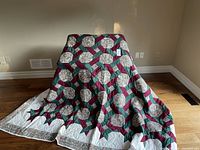 Full view of queen-sized quilted blanket draped to show overall pattern and size