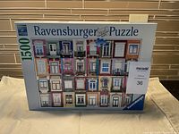 Photo of Ravensburger puzzle box with an image of colorful windows on a building and label indicating 1500 pieces