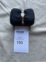 Front view of the women's Bulova watch on black cushion with lot number displayed.