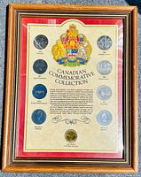 Framed collection showing all nine coins with the Canadian coat of arms and detailed informational text on the cardboard mat.