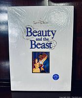 Front of the deluxe collector's VHS set in white with title and artwork, factory sealed with shrink wrap.