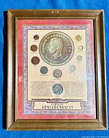 Full shot of framed UK coin collection featuring 10 coins of King George VI from 1937-1951 with decorative mat and wooden frame.