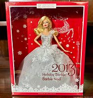 Front view of 2013 Holiday Barbie doll in original collector box showing silver gown and detailed box design with 25th Anniversary label.