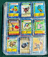 Plastic sheet with nine Digimon trading cards including Togemon, Vermilimon, Seadramon, Jaganmon, and others, showing card fronts with artwork and stats.