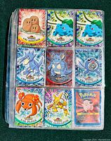 Nine-pocket page showing Diglett, Bulbasaur (two), Golduck, Nidoqueen, Poliwag, Paras, Abra discs and Clefairy card