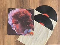 Two vinyl records with original album cover, lyric sheet, and inner sleeves for Bob Dylan's At Budokan 2LP live album.