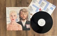 Vinyl record cover showing Annie Lennox and Dave Stewart portrait, open inner lyric sleeve, and the vinyl record itself.
