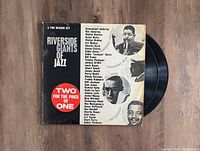 Riverside Giants of Jazz 2LP vinyl record set with cover showing featured jazz musicians and vinyl partially pulled out.