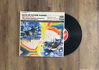 The Moody Blues Days Of Future Passed LP vinyl record with cover and record partially out showing the red and black label.