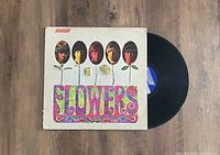 Photo of 'Flowers' LP album cover alongside the vinyl record partially visible.