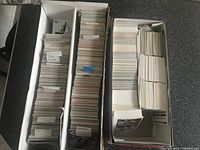 Two white boxes filled with hockey cards packed side by side showing top view with labeled dividers