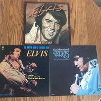 Three Elvis Presley vinyl LP albums laid out showing front covers, each representing different albums.