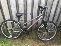 Full side profile showing the frame, tires, saddle, handlebars, and branding.