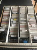 Top-down image of a large box filled with hockey cards organized by player last names starting with M and N