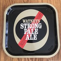Front side of the tray showing vintage Watneys Strong Pale Ale design in black, cream, red, white, and gold colors.