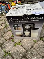 Box of Capresso Froth Xpress with product image and description showing frother and hot chocolate maker features.