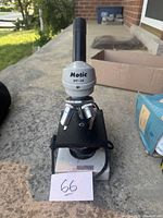 Front view of Motic SFC-2A microscope showing eyepiece, objectives, stage, and power button.