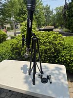 Full view of the Tele-Science telescope mounted on black tripod on outdoor table.