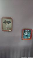 Two Coca-Cola metal trays on wall, woman with large hat and polar bear design