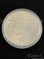 Reverse photo showing Olympic rings, Montreal 1976 text, map of North America, and denomination 5 Dollars.