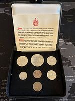 Seven 1974 Canadian coins displayed in black velvet-lined case with white satin cover and certificate card.