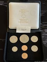 Seven Canadian coins from 1978 in original Royal Canadian Mint case. Coins viewed upright in black velvet insert with white satin-lined case top showing mint logo.