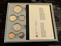 Set of 6 Canadian specimen coins from 1982 with informational insert, all secured in plastic holders within a display tray.