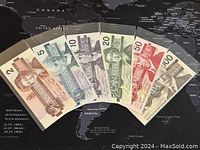 Six Birds series banknotes fanned out, showing obverses and colors