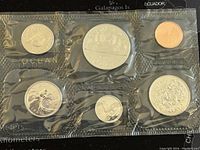 Six Canadian coins from 1987 sealed in plastic, front view showing coin designs and details.
