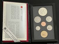 Proof set inside black textured case with '1988' on spine, open to show certificate and coin tray with 8 coins.