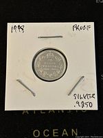 Reverse side of the 1998 Canadian 10 cents silver proof coin showing denomination, country, year, and wreath design.