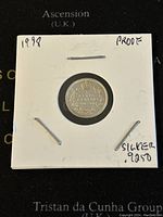 Reverse side of the 1998 Canadian silver proof 5 cents coin with wreath design and denomination encased in white holder.