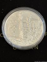 Front (reverse) side of the 2002 Canadian 1 Dollar silver coin showing Queen Elizabeth II facing a ceremonial urn and decorative elements with the denomination 'Canada Dollar'.