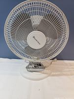 Front view of white Comfort Zone desk fan with metal grille and base controls