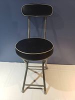 Front view of the foldable chair showing the padded seat and backrest with metal frame.