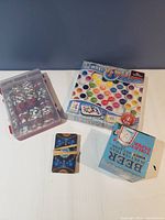 Overview of the games lot showing poker chips, cards, novelty toilet paper and board game