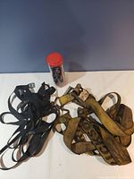 Photo showing black elastic bungee straps and yellow ratchet straps with some visible wear.