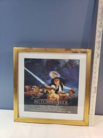 Framed Star Wars Return of the Jedi poster with Luke Skywalker holding a lightsaber and characters including Darth Vader