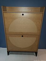 Front view of two-tier shoe cabinet showing cane panel design and metal legs