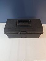 Closed black plastic toolbox with handle visible on top