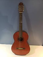 Full front view of the Yamaha classical guitar showing the wooden body and six nylon strings.