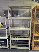 Front view of 5-tier plastic shelving unit showing spacing and size of shelves.