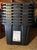 Front view of stacked HDX 27 Gallon Tough Tote bins showing label indicating size and brand.
