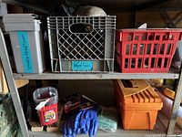Shelf including gray container labeled 'Sprinkle Head Covers', gray milk crate with knee pads, red crates, orange toolbox, blue gloves, and miscellaneous tools.